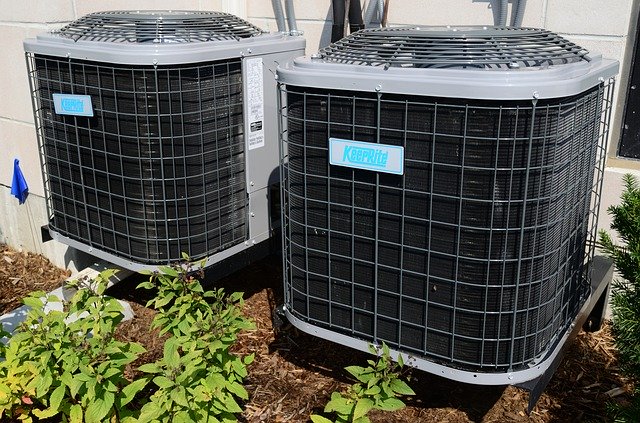 Image of two air conditioners serviced by a technician that uses an answering service for HVAC businesses