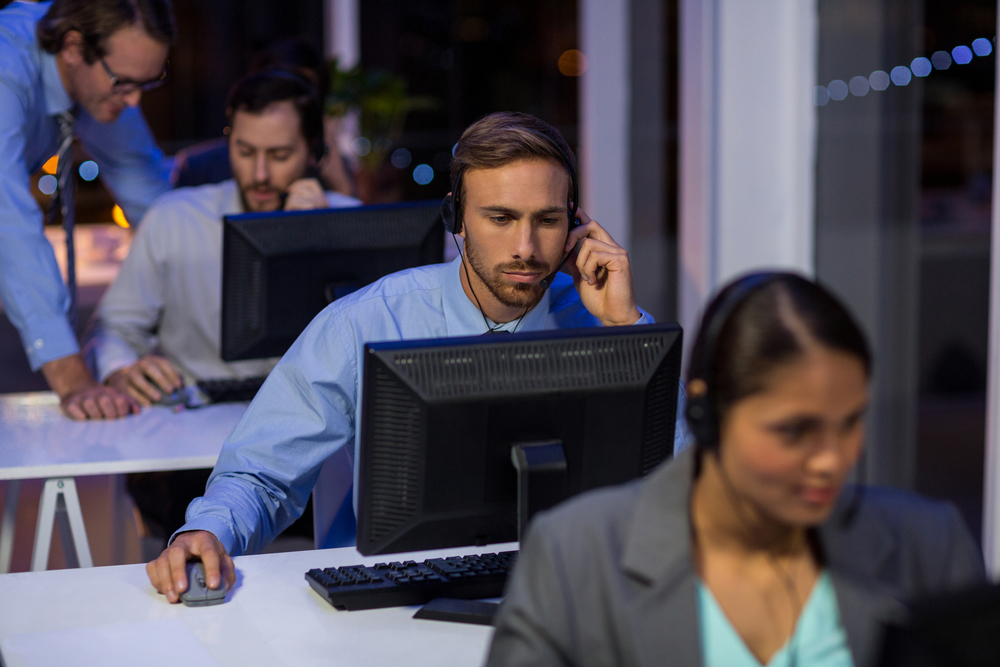 Call center agents providing customer service at night